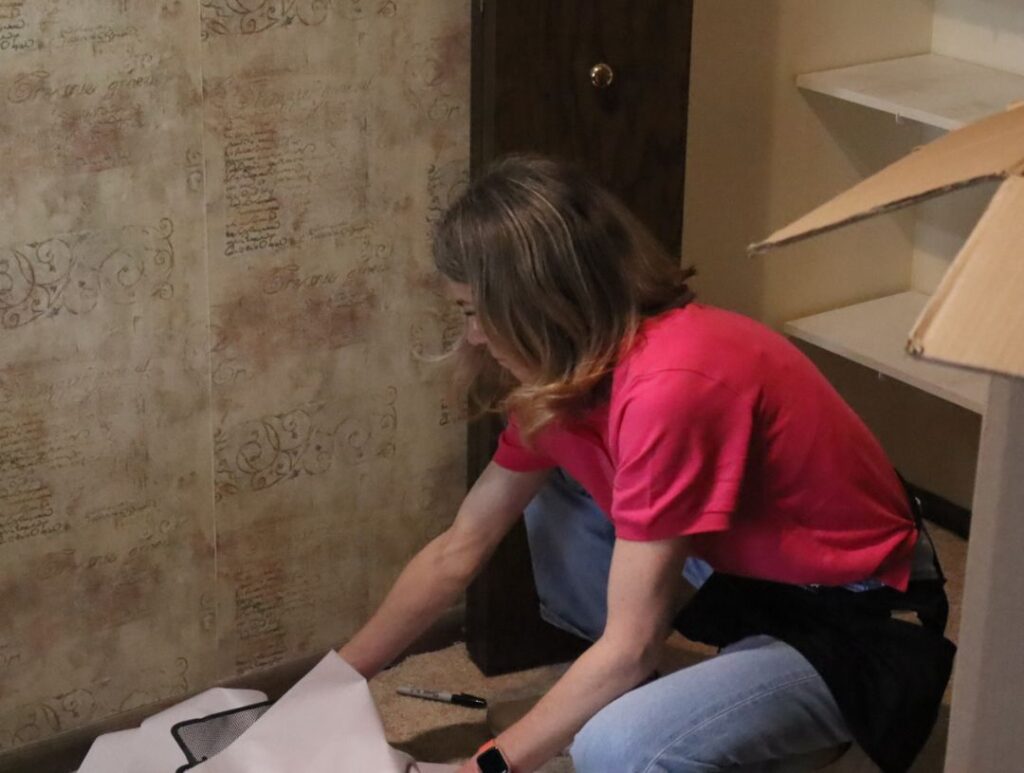 Experienced move manager wrapping and labeling valuable belongings