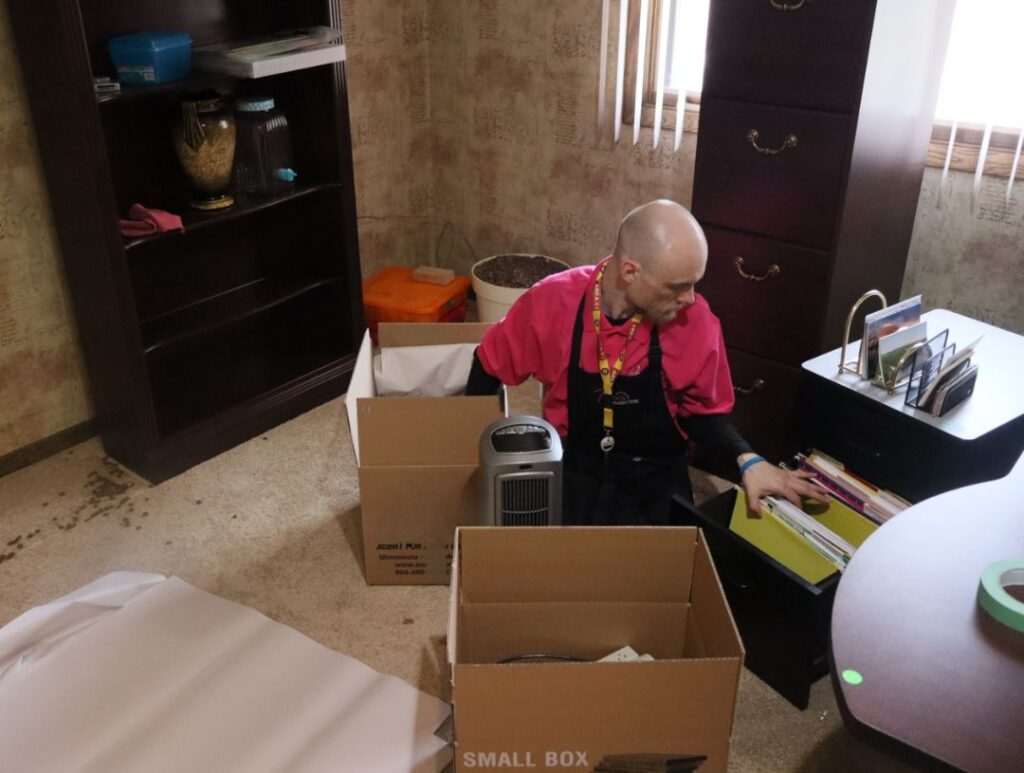 Move manager unpacking boxes
