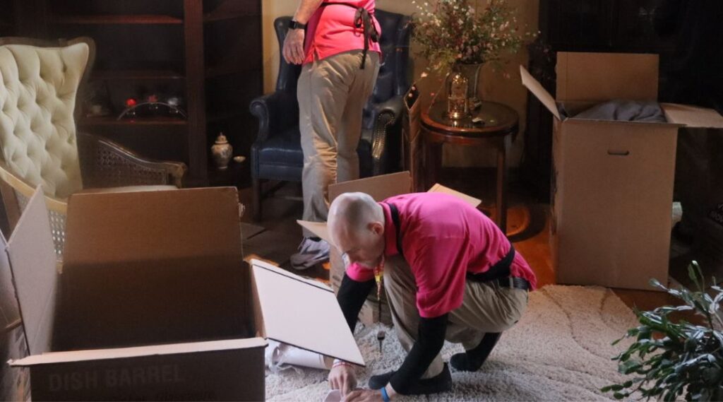 two move managers packing up a clients house