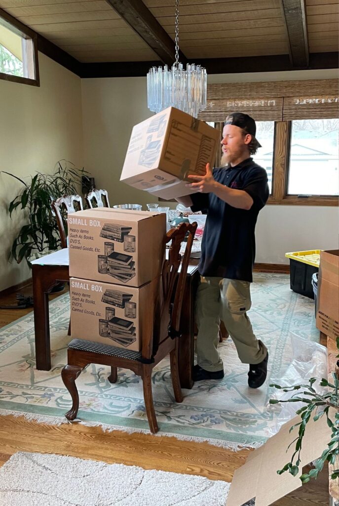 roses daughters mover carrying boxes full of items