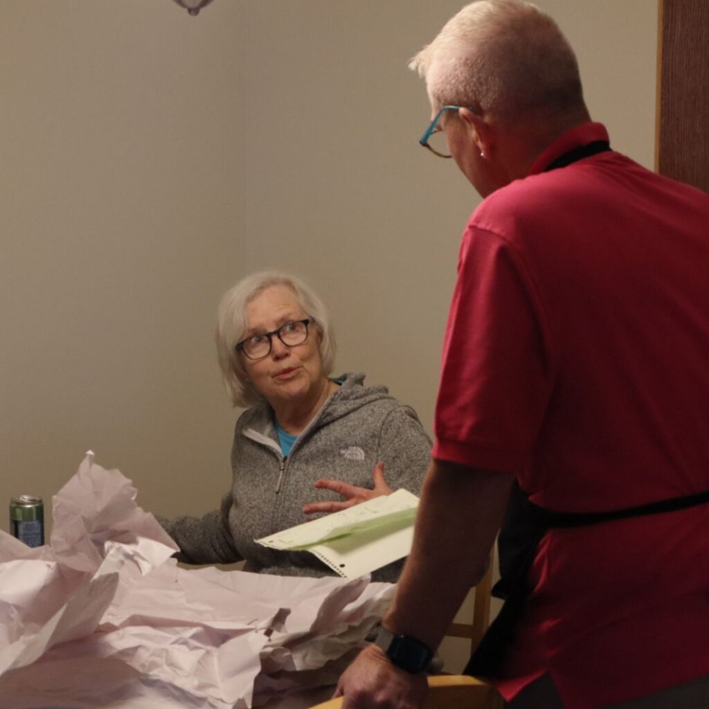eddie from roses daughters having a conversation with a client at the dinner table